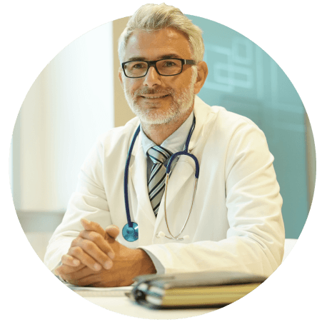 White male doctor smiling at office desk