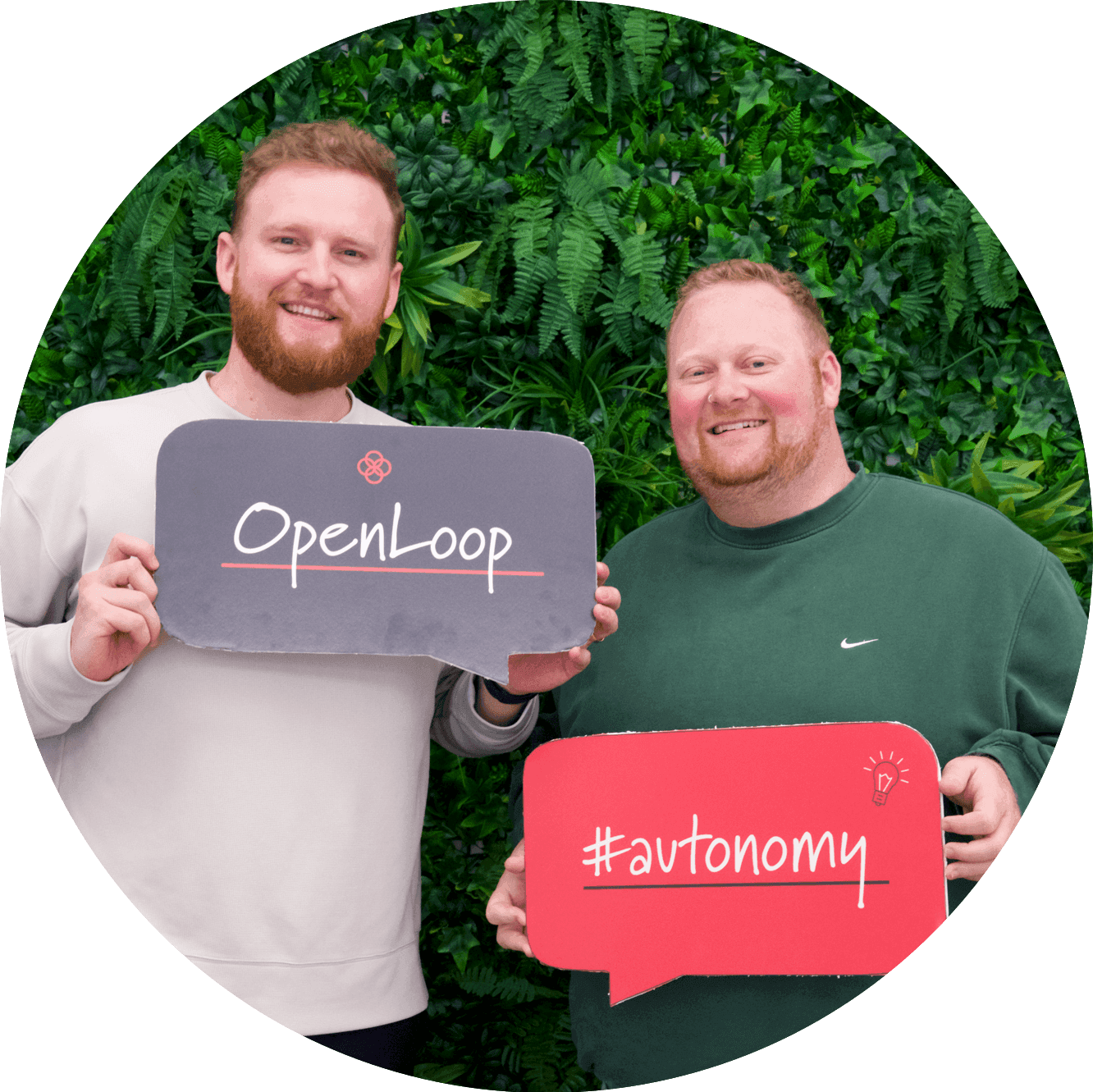 OpenLoop female employees holding signs saying OpenLoop, #competence, #belonging