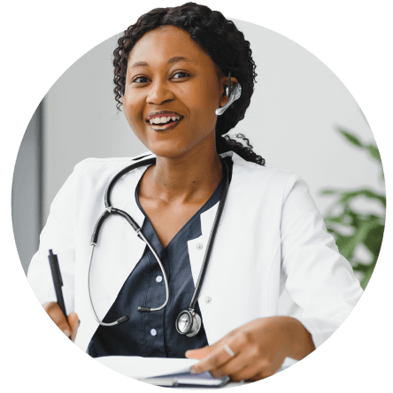 Black female physician smiling and on phone call with patient