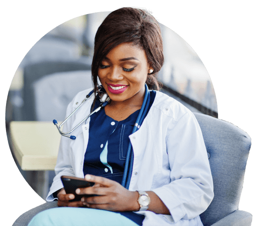 Black female provider smiling and scrolling on phone