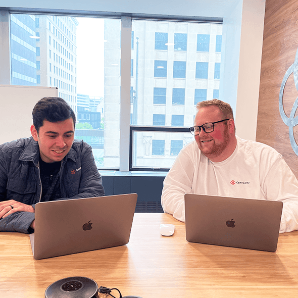 Nik Wasik, Customer Success Specialist, and Noah VanEldik, Clinical Operations Program Manager, in a meeting at OpenLoop office.
